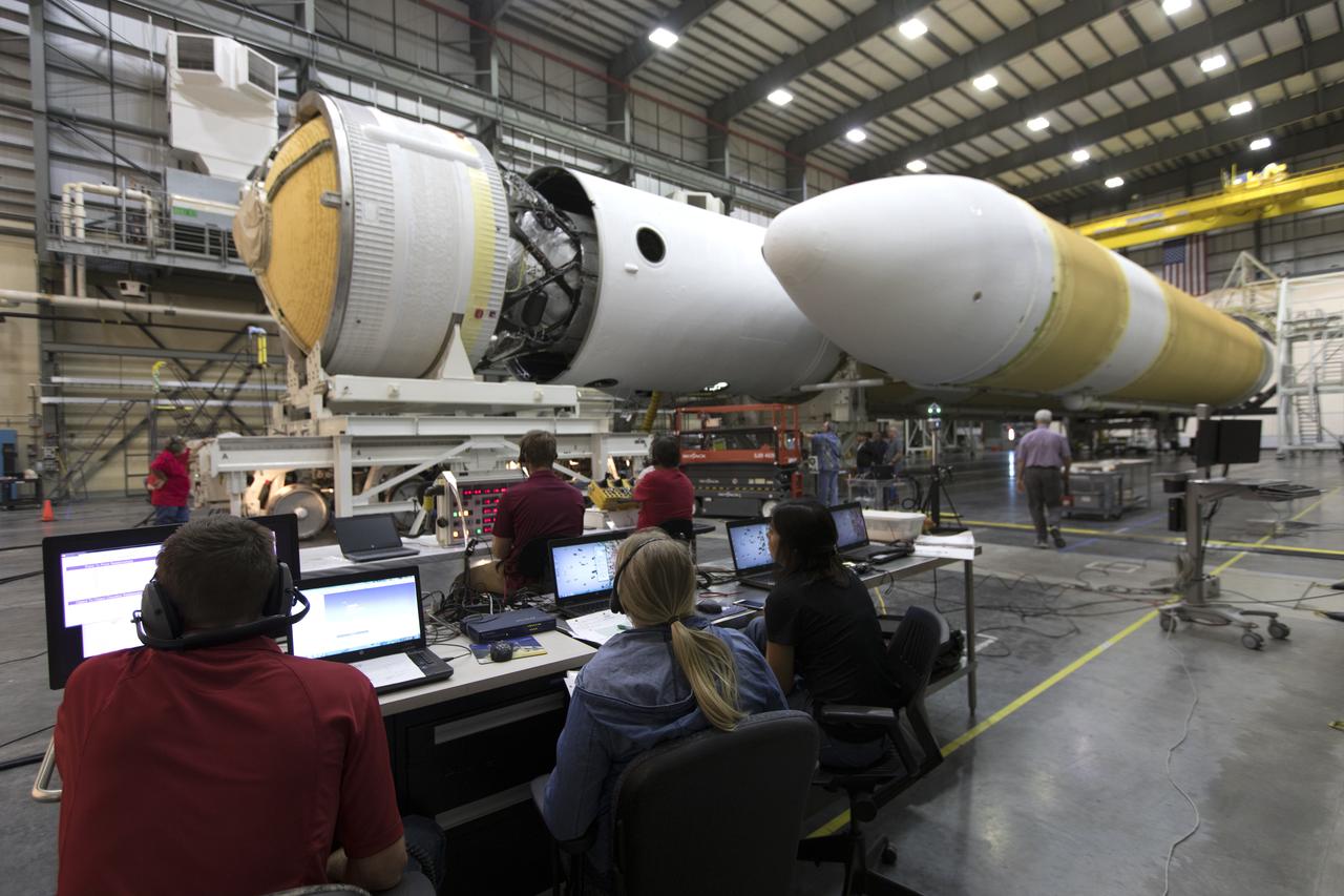United Launch Alliance (ULA) workers monitor the progress as the second stage of a ULA Delta IV Heavy is mated to the common booster core inside the Horizontal Integration Facility near Space Launch Complex 37 at Cape Canaveral Air Force Station in Florida. The Delta IV Heavy will launch NASA's upcoming Parker Solar Probe mission in July 2018. The mission will perform the closest-ever observations of a star when it travels through the Sun's atmosphere, called the corona. The probe will rely on measurements and imaging to revolutionize our understanding of the corona and the Sun-Earth connection.