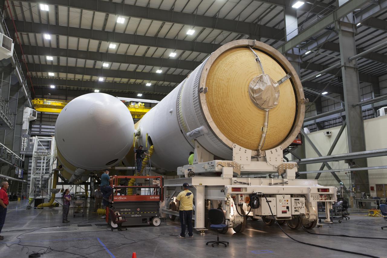 United Launch Alliance (ULA) workers assist as the second stage of a ULA Delta IV Heavy is mated to the common booster core inside the Horizontal Integration Facility near Space Launch Complex 37 at Cape Canaveral Air Force Station in Florida. The Delta IV Heavy will launch NASA's upcoming Parker Solar Probe mission in July 2018. The mission will perform the closest-ever observations of a star when it travels through the Sun's atmosphere, called the corona. The probe will rely on measurements and imaging to revolutionize our understanding of the corona and the Sun-Earth connection.