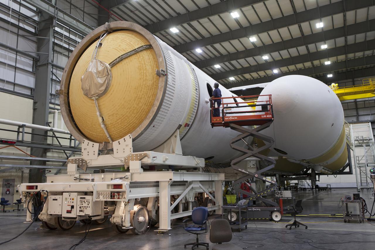 A United Launch Alliance (ULA) worker on a scissor lift watches as the second stage of a ULA Delta IV Heavy is mated to the common booster core inside the Horizontal Integration Facility near Space Launch Complex 37 at Cape Canaveral Air Force Station in Florida. The Delta IV Heavy will launch NASA's upcoming Parker Solar Probe mission in July 2018. The mission will perform the closest-ever observations of a star when it travels through the Sun's atmosphere, called the corona. The probe will rely on measurements and imaging to revolutionize our understanding of the corona and the Sun-Earth connection.