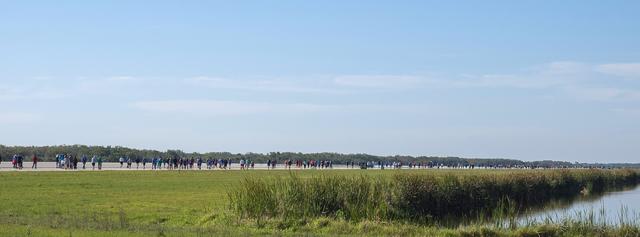 A line of Kennedy Space Center employees and guests stretches down the Shuttle Landing Facility Runway during the KSC Walk Run. The annual event, part of Kennedy’s Safety and Health Days, offers 10K, 5K and 2-mile options in the spirit of friendly competition.