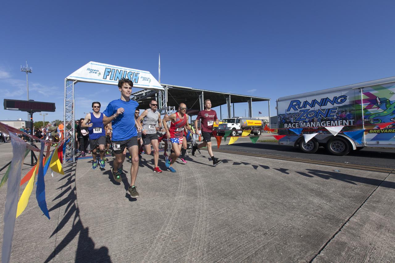 Kennedy Space Center employees and guests cross the finish line during the KSC Walk Run on the Shuttle Landing Facility runway. The annual event, part of Kennedy’s Safety and Health Days, offers 10K, 5K and 2-mile options in the spirit of friendly competition.