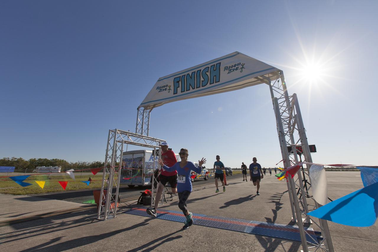 Kennedy Space Center employees and guests cross the finish line during the KSC Walk Run on the Shuttle Landing Facility runway. The annual event, part of Kennedy’s Safety and Health Days, offers 10K, 5K and 2-mile options in the spirit of friendly competition.