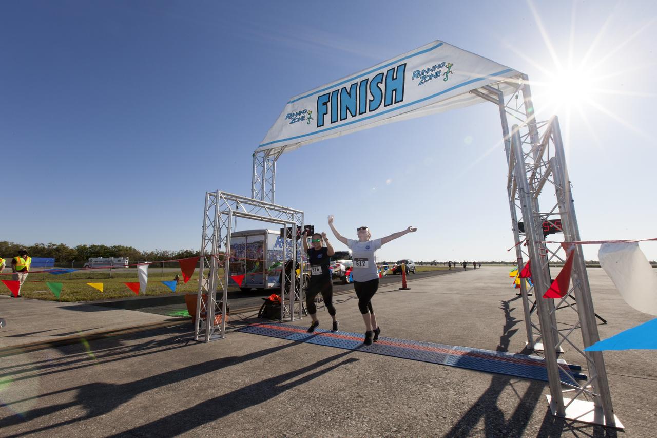Kennedy Space Center employees and guests cross the finish line during the KSC Walk Run on the Shuttle Landing Facility runway. The annual event, part of Kennedy’s Safety and Health Days, offers 10K, 5K and 2-mile options in the spirit of friendly competition.