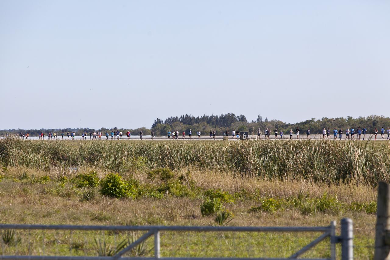A line of Kennedy Space Center employees and guests stretches down the Shuttle Landing Facility Runway during the KSC Walk Run. The annual event, part of Kennedy’s Safety and Health Days, offers 10K, 5K and 2-mile options in the spirit of friendly competition.