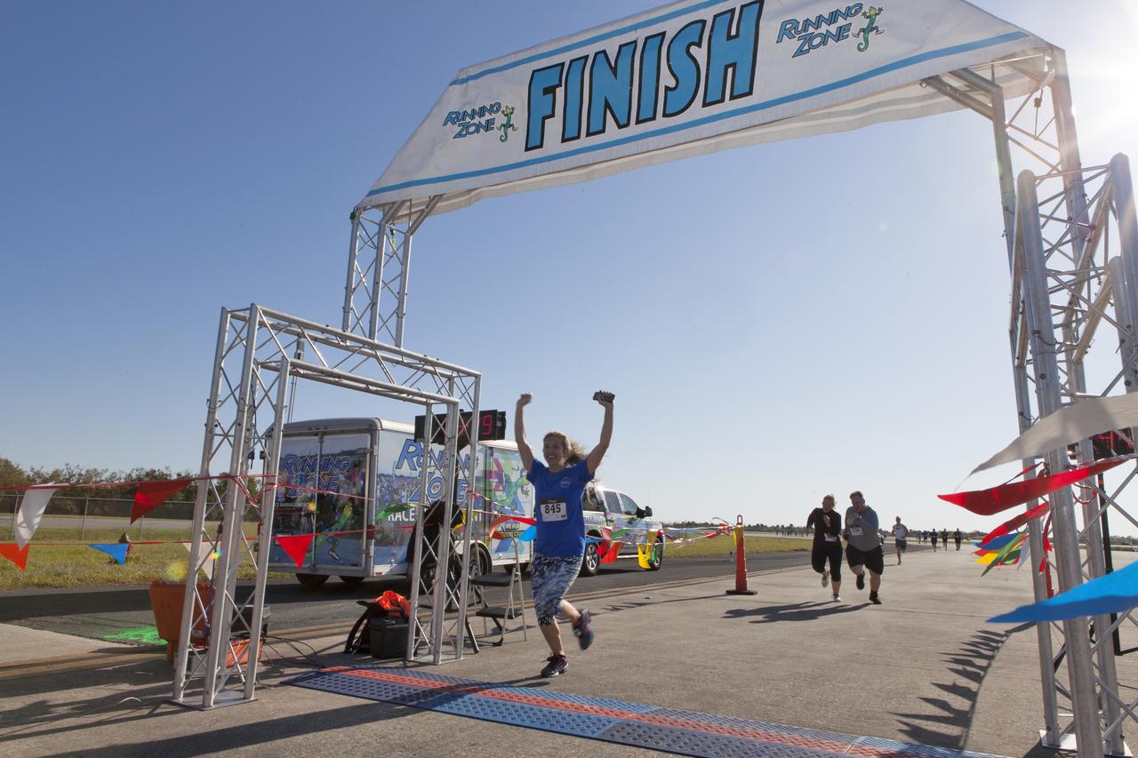 Kennedy Space Center employees and guests approach the finish line during the KSC Walk Run on the Shuttle Landing Facility runway. The annual event, part of Kennedy’s Safety and Health Days, offers 10K, 5K and 2-mile options in the spirit of friendly competition.