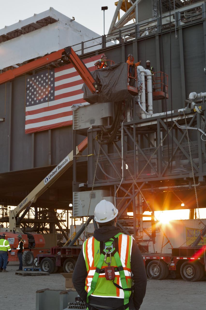 Construction workers with JP Donovan assist with preparations to lift and install the Interim Cryogenic Propulsion Stage Umbilical on the tower of the mobile launcher at NASA's Kennedy Space Center in Florida. The last of the large umbilicals to be installed, the ICPSU will provide super-cooled hydrogen and liquid oxygen to the Space Launch System (SLS) rocket's interim cryogenic propulsion stage, or upper stage, at T-0 for Exploration Mission-1. The umbilical is located at about the 240-foot-level of the mobile launcher and will supply fuel, oxidizer, gaseous helium, hazardous gas leak detection, electrical commodities and environment control systems to the upper stage of the SLS rocket during launch. Exploration Ground Systems is overseeing installation of the umbilicals on the ML.