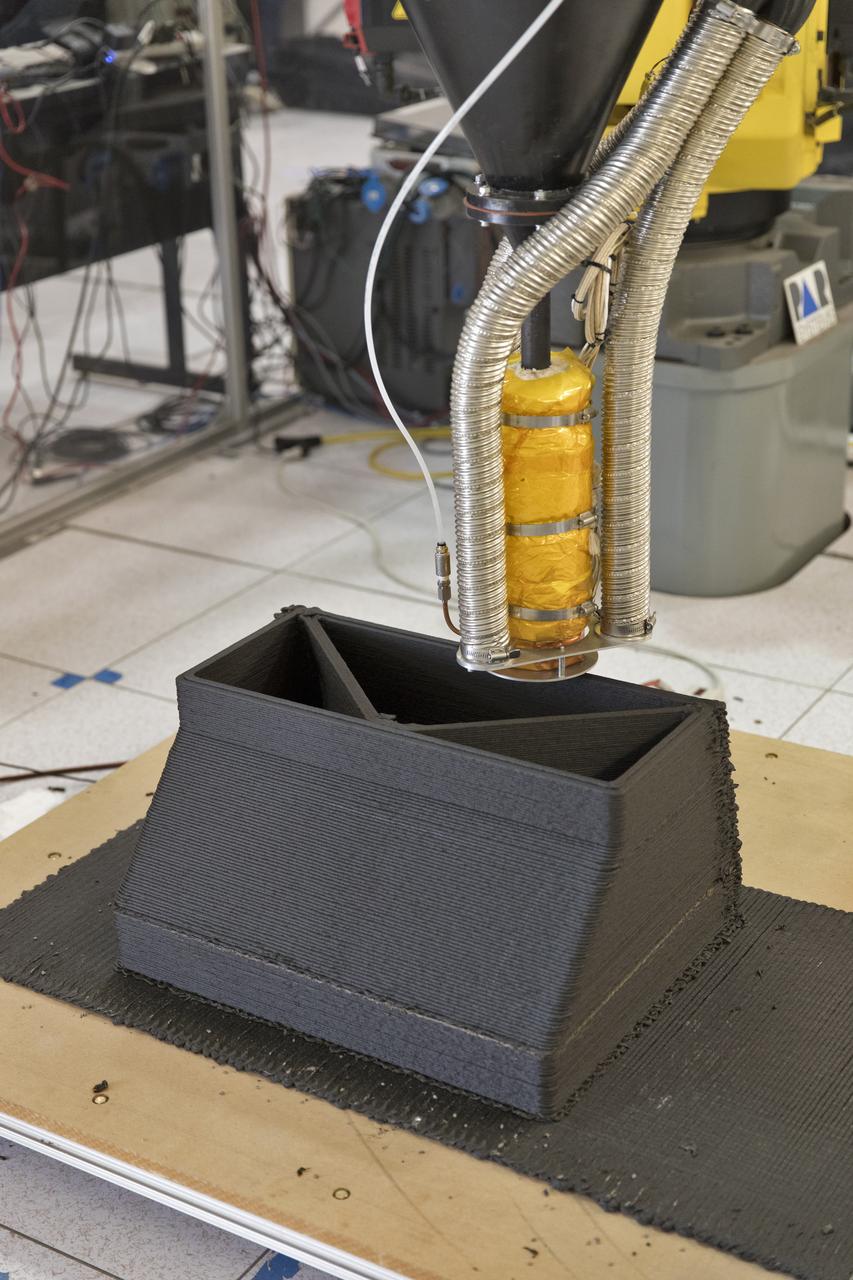 A Zero Launch Mass 3-D printer is being tested at the Swamp Works at NASA's Kennedy Space Center in Florida. The printer can be used for construction projects on the Moon and Mars. Zero launch mass refers to the fact that the printer uses pellets made from simulated lunar regolith, or dirt, and polymers. This will prove that space explorers can use resources at their destination instead of taking everything with them, saving them launch mass and money. The Kennedy team is working with Marshall Space Flight Center in Huntsville, Alabama, and the U.S. Army Corps of Engineers to develop a system that can 3-D print barracks in remote locations on Earth, using the resources they have where they are. 