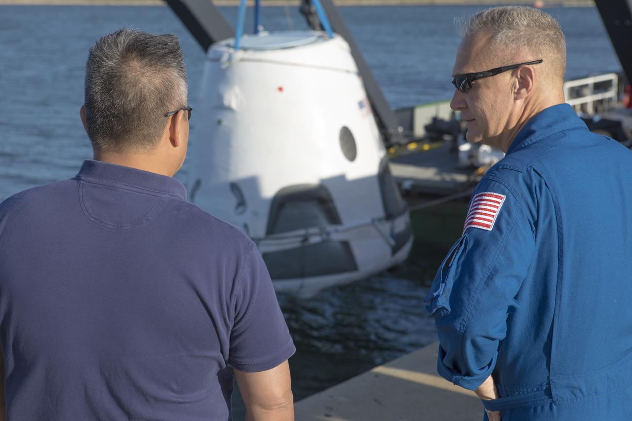 At Cape Canaveral Air Force Station's Naval Ordnance Test Unit basin in Florida, Commercial Crew Program astronaut Doug Hurley, right, observes operation of the SpaceX recovery ship. During a recent visit to the Kennedy Space Center, the crew members were given an up-close look at preparations for the SpaceX Crew Dragon flight tests.