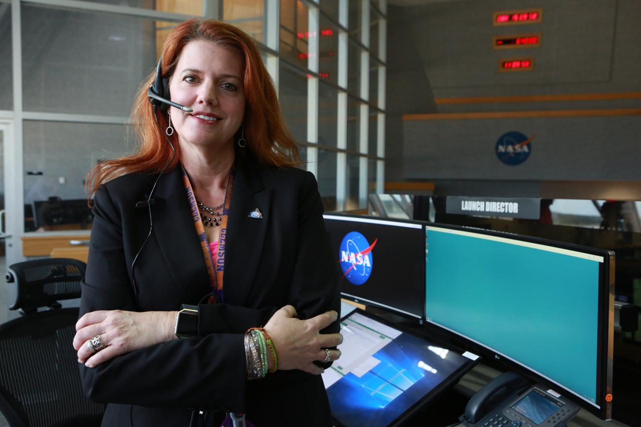 NASA Launch Director Charlie Blackwell-Thompson stands next to her console in Firing Room 1 at the Kennedy Space Center's Launch Control Center during a countdown simulation for Exploration Mission 1. It was the agency's first simulation of a portion of the countdown for the first launch of a Space Launch System rocket and Orion spacecraft that will eventually take astronauts beyond low-Earth orbit to destinations such as the Moon and Mars.