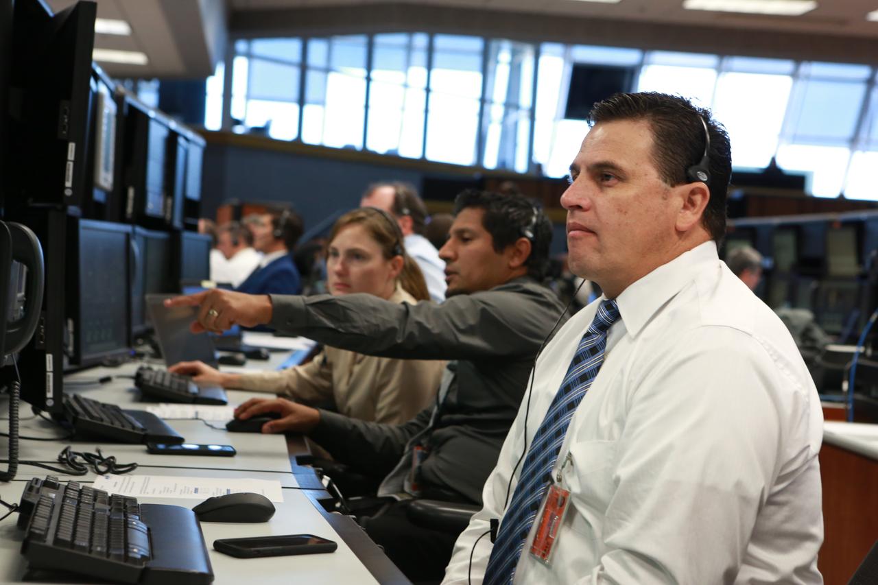 NASA Operation Project Engineer Rommel Rubio monitors operations from his position in Firing Room 1 at the Kennedy Space Center's Launch Control Center during a countdown simulation for Exploration Mission 1. It was the agency's first simulation of a portion of the countdown for the first launch of a Space Launch System rocket and Orion spacecraft that will eventually take astronauts beyond low-Earth orbit to destinations such as the Moon and Mars.