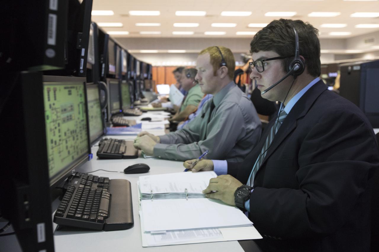 Liquid Oxygen Systems Engineer Quinten Jones, left and Liquid Oxygen Systems Engineer Andrew "Kody" Smitherman, both of Jacobs, monitor operation from his position in Firing Room 1 at the Kennedy Space Center's Launch Control Center during a countdown simulation for Exploration Mission 1. It was the agency's first simulation of a portion of the countdown for the first launch of a Space Launch System rocket and Orion spacecraft that will eventually take astronauts beyond low-Earth orbit to destinations such as the Moon and Mars.