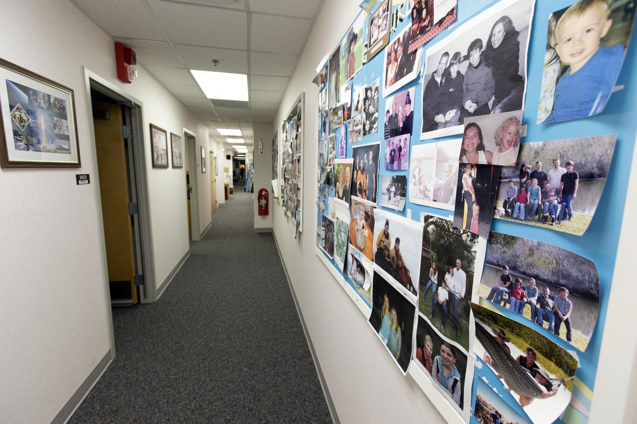Modifications and upgrades are underway inside the Astronaut Crew Quarters in the Neil Armstrong Operations and Checkout Building at NASA's Kennedy Space Center in Florida. New carpeting and trim has been installed along a hallway and into some of the bedrooms. Photos of astronauts' families line the walls. The crew quarters are being prepared for the next generation of space explorers. The historic facility housed Apollo and space shuttle astronauts before and after their missions into space.