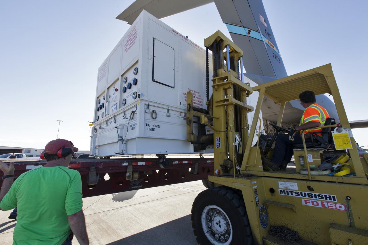 A forklift operator latches onto the shipping container with NASA's Parker Solar Probe inside, after it was offloaded from a U.S. Air Force C-5 transport aircraft at Space Coast Regional Airport in Titusville, Florida. The spacecraft will be transported to the Astrotech processing facility near the agency's Kennedy   Space Center. The Parker Solar Probe will launch on a United Launch Alliance Delta IV Heavy rocket from Space Launch Complex 37 at Cape Canaveral Air Force Station in Florida in July 2018. The mission will perform the closest-ever observations of a star when it travels through the Sun's atmosphere, called the corona. The probe will rely on measurements and imaging to revolutionize our understanding of the corona and the Sun-Earth connection.