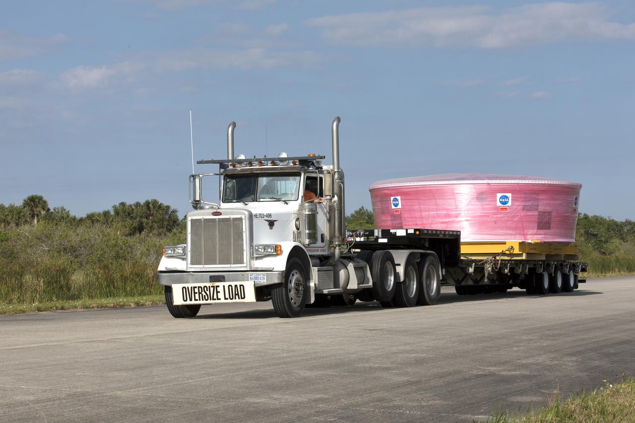 The Orion Stage Adapter (OSA) is secured on a flatbed transporter for the move to the Space Station Processing Facility (SSPF) at NASA's Kennedy Space Center in Florida. The OSA is the second flight-hardware section of the agency's Space Launch System (SLS) rocket to arrive at Kennedy. The OSA will connect the Orion spacecraft to the upper part of the SLS, the interim cryogenic propulsion stage (ICPS). Both the OSA and ICPS are being stored for processing in the SSPF in preparation for Exploration Mission-1, the first uncrewed, integrated launch of the SLS rocket and Orion spacecraft. 