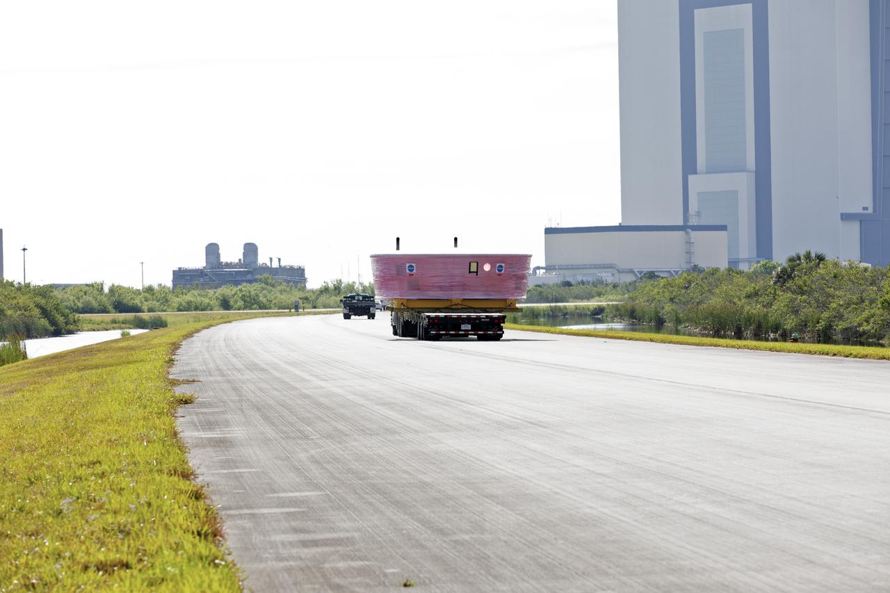The Orion Stage Adapter (OSA), secured on a flatbed transporter, is moved along State Road 3 to the Space Station Processing Facility (SSPF) at NASA's Kennedy Space Center in Florida. The OSA is the second flight-hardware section of the agency's Space Launch System (SLS) rocket to arrive at Kennedy. The OSA will connect the Orion spacecraft to the upper part of the SLS, the interim cryogenic propulsion stage (ICPS). Both the OSA and ICPS are being stored for processing in the SSPF in preparation for Exploration Mission-1, the first uncrewed, integrated launch of the SLS rocket and Orion spacecraft. 