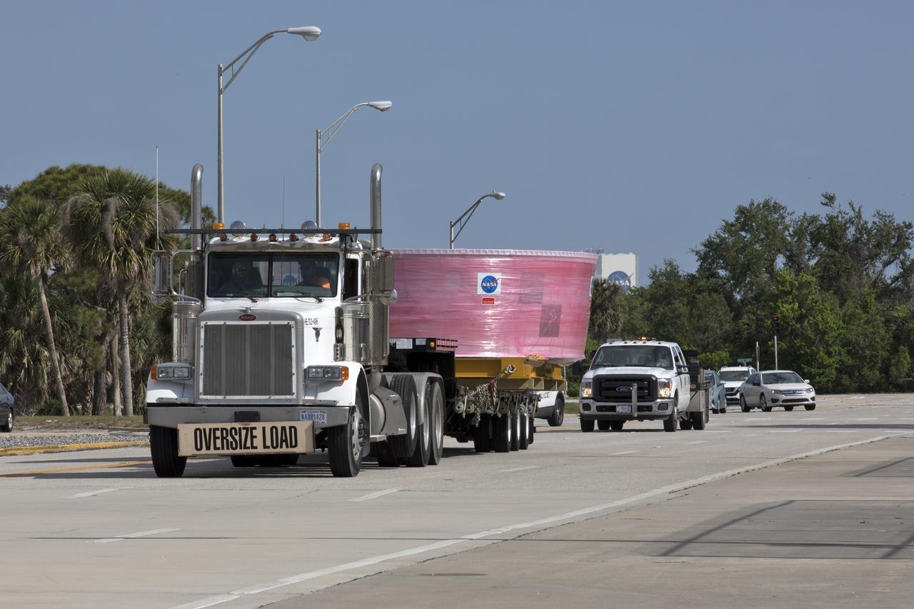 The Orion Stage Adapter (OSA), secured on flatbed transporter, is moved along State Road 3 to the Space Station Processing Facility (SSPF) at NASA's Kennedy Space Center in Florida. The OSA is the second flight-hardware section of the agency's Space Launch System (SLS) rocket to arrive at Kennedy. The OSA will connect the Orion spacecraft to the upper part of the SLS, the interim cryogenic propulsion stage (ICPS). Both the OSA and ICPS are being stored for processing in the SSPF in preparation for Exploration Mission-1, the first uncrewed, integrated launch of the SLS rocket and Orion spacecraft.