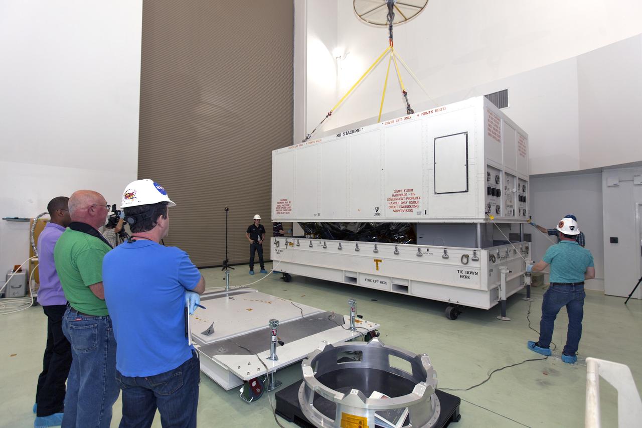At the Astrotech processing facility in Titusville, Florida, near NASA's Kennedy Space Center, technicians and engineers remove NASA's Parker Solar Probe from its shipping container on Wednesday, April 4, 2018. The Parker Solar Probe will launch on a United Launch Alliance Delta IV Heavy rocket from Space Launch Complex 37 at Cape Canaveral Air Force Station in Florida no earlier than Aug. 4, 2018. The mission will perform the closest-ever observations of a star when it travels through the Sun's atmosphere, called the corona. The probe will rely on measurements and imaging to revolutionize our understanding of the corona and the Sun-Earth connection.