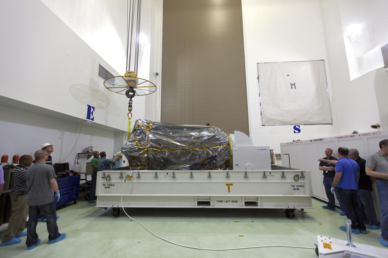 At the Astrotech processing facility in Titusville, Florida, near NASA's Kennedy Space Center, technicians and engineers remove NASA's Parker Solar Probe from its shipping container on Wednesday, April 4, 2018. The Parker Solar Probe will launch on a United Launch Alliance Delta IV Heavy rocket from Space Launch Complex 37 at Cape Canaveral Air Force Station in Florida no earlier than Aug. 4, 2018. The mission will perform the closest-ever observations of a star when it travels through the Sun's atmosphere, called the corona. The probe will rely on measurements and imaging to revolutionize our understanding of the corona and the Sun-Earth connection.