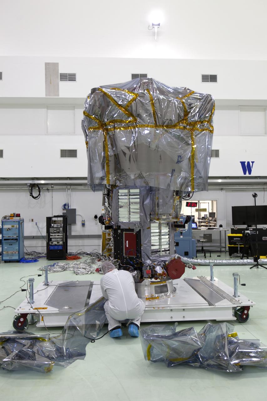 At the Astrotech processing facility in Titusville, Florida, near NASA's Kennedy Space Center, technicians and engineers remove NASA's Parker Solar Probe from its shipping bag on Wednesday, April 4, 2018. The Parker Solar Probe will launch on a United Launch Alliance Delta IV Heavy rocket from Space Launch Complex 37 at Cape Canaveral Air Force Station in Florida no earlier than Aug. 4, 2018. The mission will perform the closest-ever observations of a star when it travels through the Sun's atmosphere, called the corona. The probe will rely on measurements and imaging to revolutionize our understanding of the corona and the Sun-Earth connection.