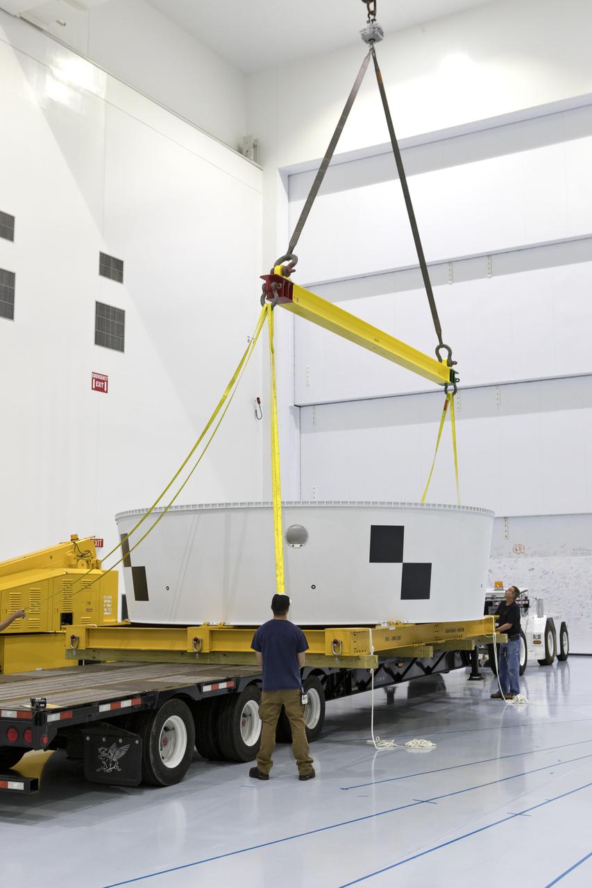 Inside the Space Station Processing Facility (SSPF) high bay at NASA's Kennedy Space Center in Florida, workers assist as a crane lifts the Orion Stage Adapter (OSA) up from the flatbed of a transport truck. The OSA is the second flight-hardware section of the agency's Space Launch System (SLS) rocket to arrive at Kennedy. The OSA will connect the Orion spacecraft to the upper part of the SLS, the interim cryogenic propulsion stage (ICPS). Both the OSA and ICPS are being stored for processing in the center's SSPF in preparation for Exploration Mission-1, the first uncrewed, integrated launch of the SLS rocket and Orion spacecraft. 