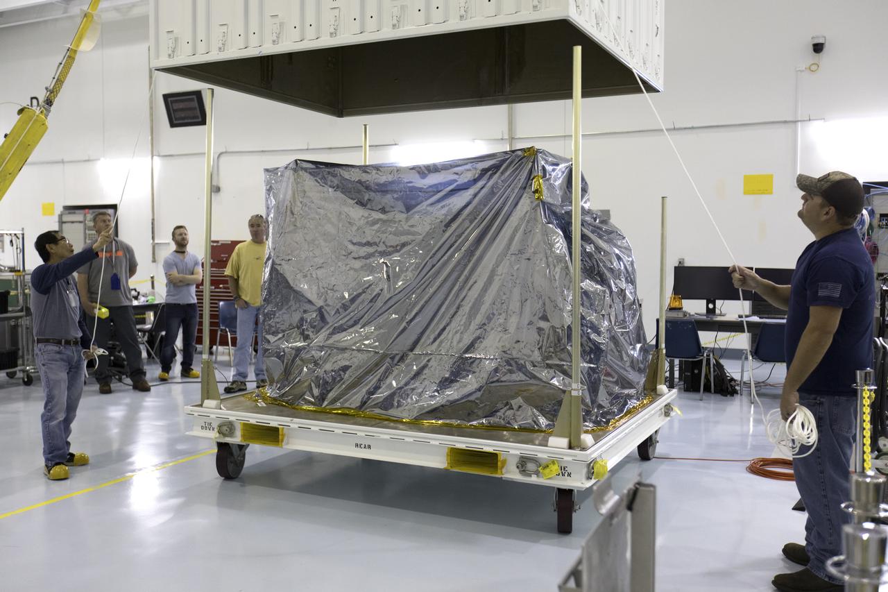 In the Space Station Processing Facility at NASA's Kennedy Space Center in Florida, the ECOsystem Spaceborne Thermal Radiometer Experiment on Space Station (ECOSTRESS) is removed from its shipping container. ECOSTRESS is designed to monitor one of the most basic processes in living plants: the loss of water through the tiny pores in leaves. ECOSTRESS will launch to the International Space Station aboard a Dragon spacecraft launched by a Falcon 9 rocket on the SpaceX CRS-15 mission in June 2018.