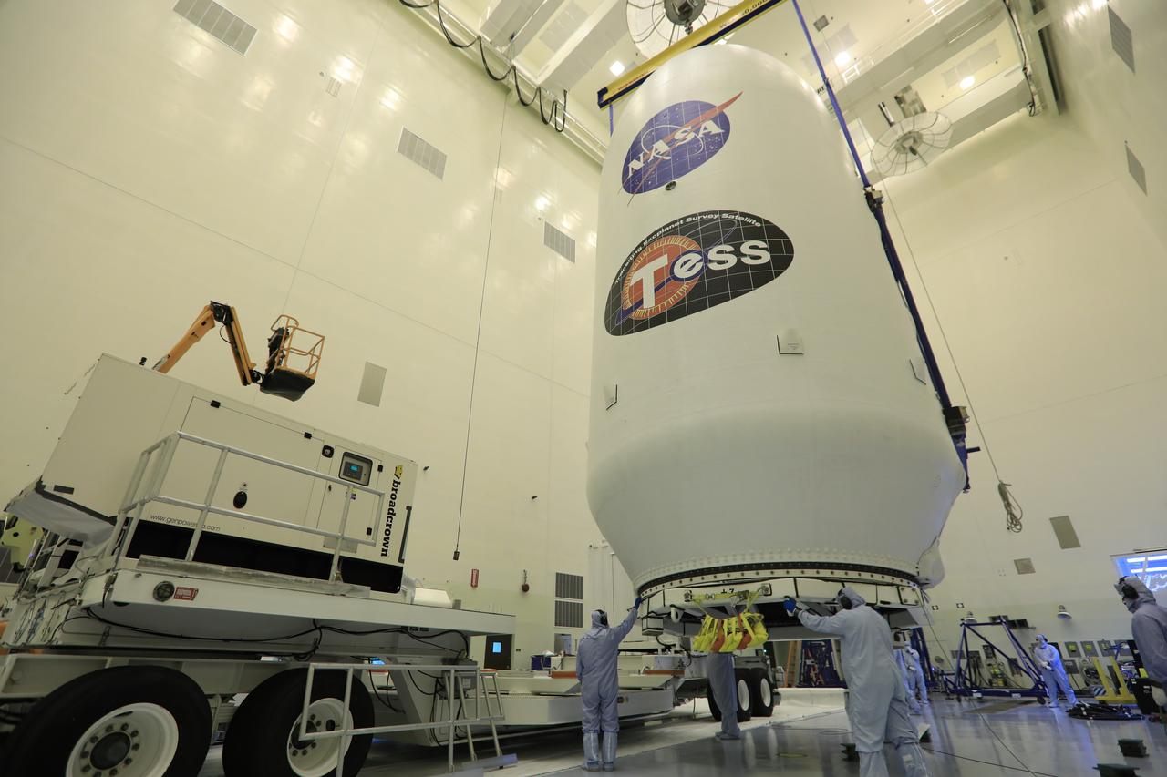 Inside the Payload Hazardous Servicing Facility at NASA's Kennedy Space Center in Florida, technicians assist as the SpaceX payload fairing containing the agency's Transiting Exoplanet Survey Satellite (TESS) is moved by crane to a transporter. The fairing will be moved to Space Launch Complex 40 at Cape Canaveral Air Force Station. TESS is scheduled to launch on the SpaceX Falcon 9 rocket at 6:32 p.m. EDT on April 16. The satellite is the next step in NASA's search for planets outside our solar system, known as exoplanets. TESS is a NASA Astrophysics Explorer mission led and operated by MIT in Cambridge, Massachusetts, and managed by NASA’s Goddard Space Flight Center in Greenbelt, Maryland. Dr. George Ricker of MIT’s Kavli Institute for Astrophysics and Space Research serves as principal investigator for the mission. Additional partners include Orbital ATK, NASA’s Ames Research Center, the Harvard-Smithsonian Center for Astrophysics and the Space Telescope Science Institute. More than a dozen universities, research institutes and observatories worldwide are participants in the mission. NASA’s Launch Services Program is responsible for launch management.