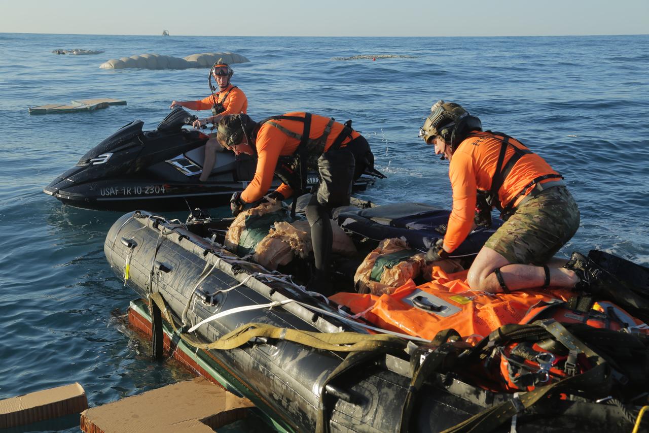 Pararescue specialists from the 304th Rescue Squadron, located in Portland, Oregon and supporting the 45th Operations Group’s Detachment 3, based out of Patrick Air Force Base, prepare equipment during an April astronaut rescue exercise with NASA’s Commercial Crew Program and SpaceX off of Florida’s eastern coast. The pararescue specialists, also known as “Guardian Angels,” jumped from military aircraft and simulated a rescue operation to demonstrate their ability to safely remove crew from the SpaceX Crew Dragon in the unlikely event of an emergency landing. The pararescue specialists are fully qualified paramedics able to perform field surgery, if necessary. 