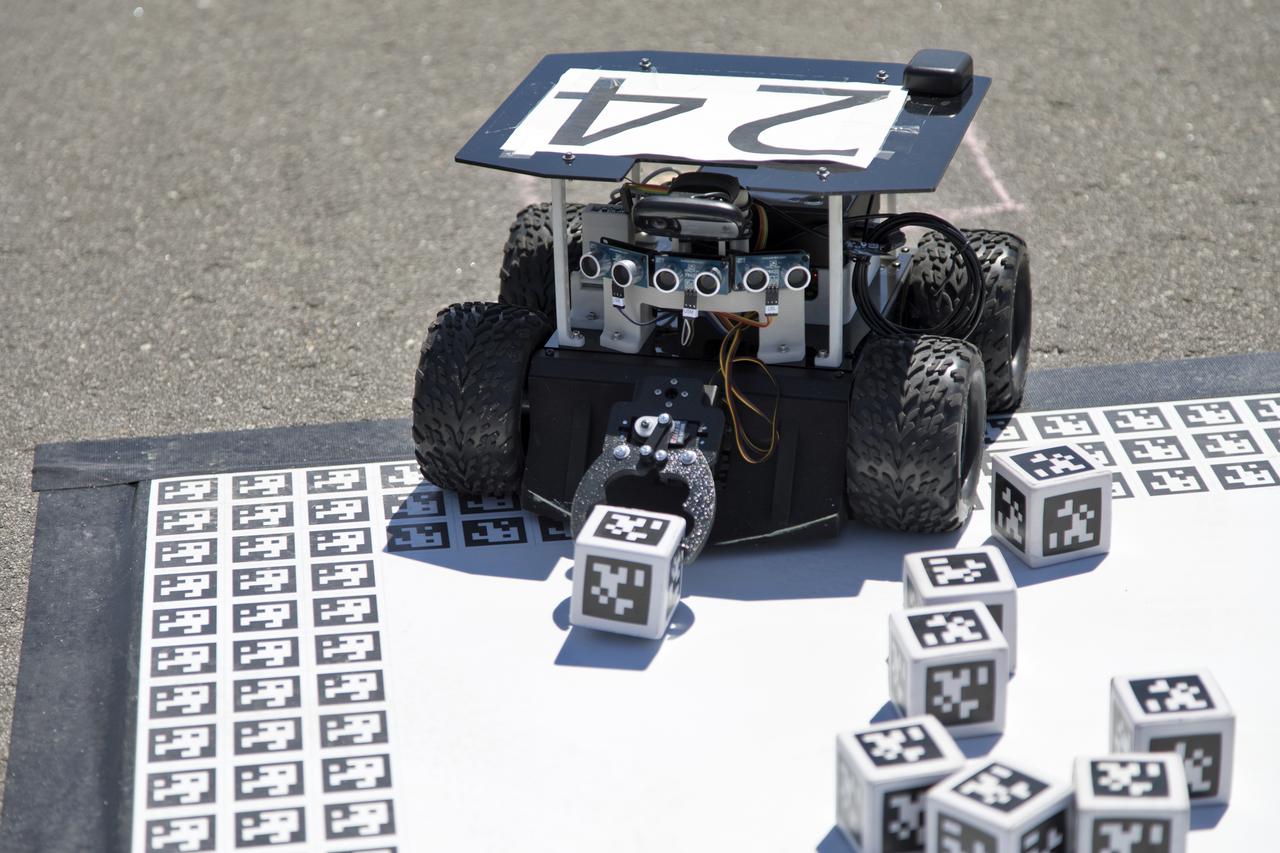 In the Swarmathon competition at the Kennedy Space Center Visitor Complex, students were asked to develop computer code for the small robots, programming them to look for "resources" in the form of AprilTag cubes, similar to barcodes. Teams developed search algorithms for the Swarmies to operate autonomously, communicating and interacting as a collective swarm similar to ants foraging for food. In the spaceport's third annual Swarmathon, 23 teams represented 24 minority serving universities and community colleges were invited to develop software code to operate these innovative robots known as "Swarmies" to help find resources when astronauts explore distant locations, such as the Moon or Mars.