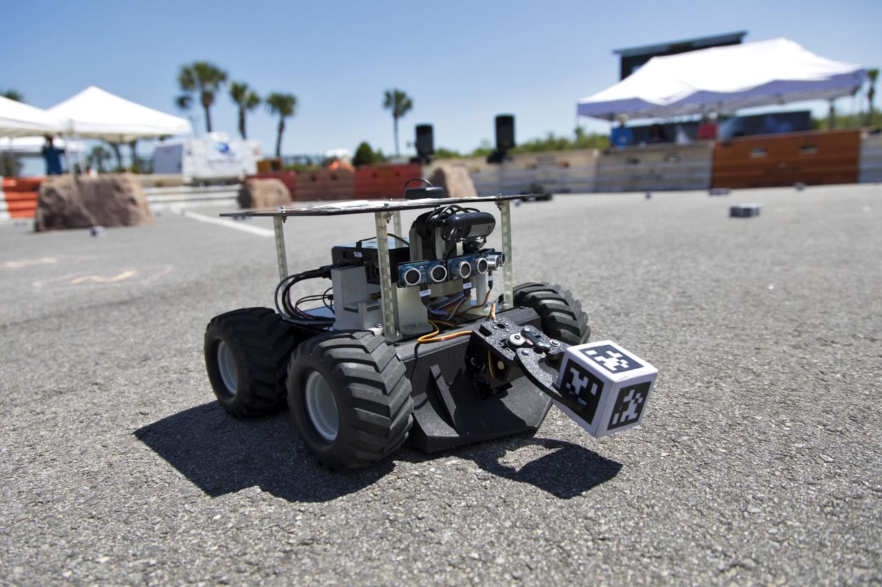 In the Swarmathon competition at the Kennedy Space Center Visitor Complex, students were asked to develop computer code for the small robots, programming them to look for "resources" in the form of AprilTag cubes, similar to barcodes. Teams developed search algorithms for the Swarmies to operate autonomously, communicating and interacting as a collective swarm similar to ants foraging for food. In the spaceport's third annual Swarmathon, 23 teams represented 24 minority serving universities and community colleges were invited to develop software code to operate these innovative robots known as "Swarmies" to help find resources when astronauts explore distant locations, such as the Moon or Mars.