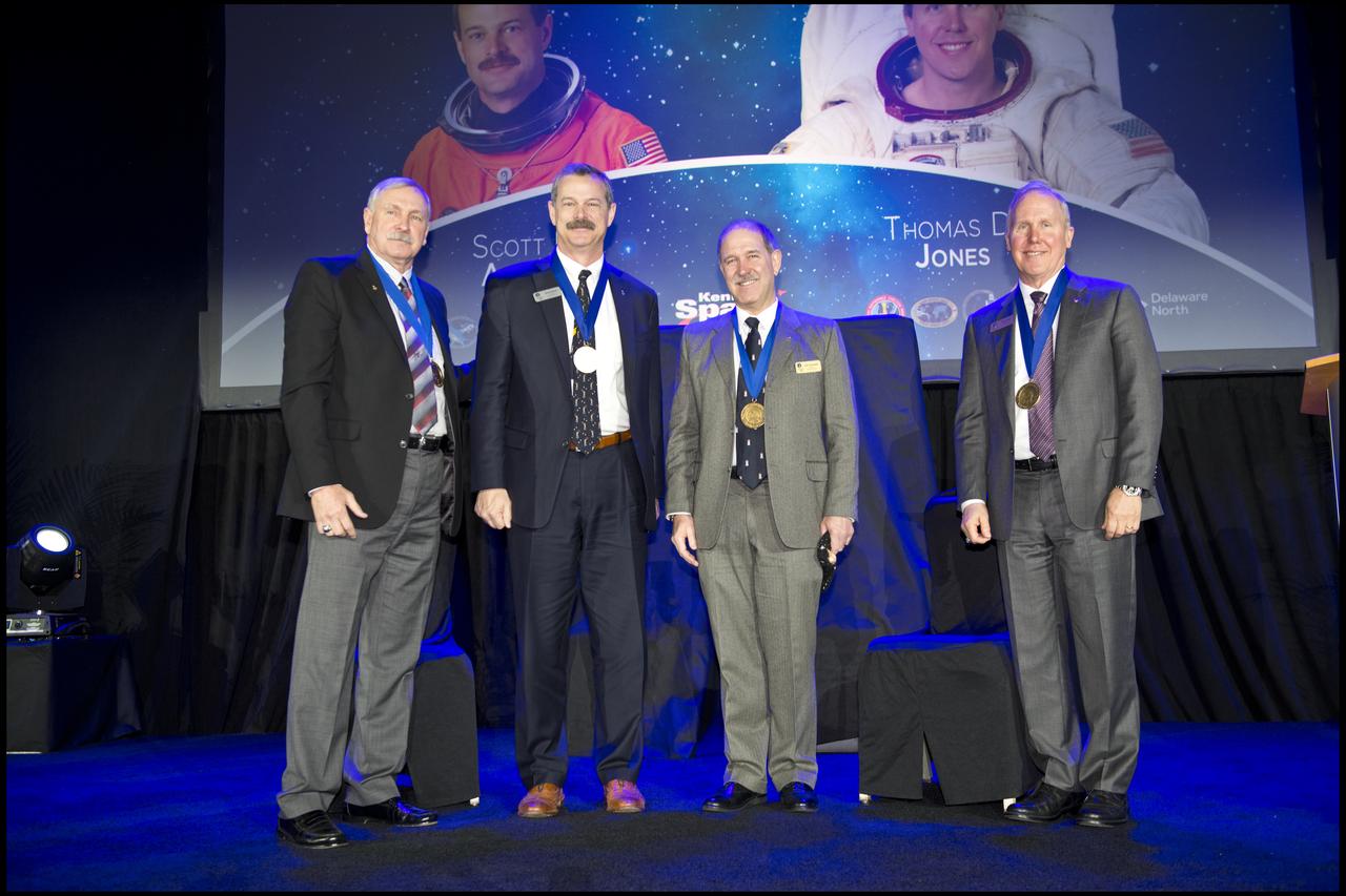 Inside the Space Shuttle Atlantis attraction at NASA’s Kennedy Space Center Visitor Complex in Florida, two space explorers, Scott D. Altman, second from left, and Thomas D. Jones, Ph.D., far right, are inducted into the U.S. Astronaut Hall of Fame Class of 2018. At far left is Hall of Famer Curt Brown, board chairman, Astronaut Scholarship Foundation, who inducted Altman and Jones into the AHOF. Second from right is Hall of Famer John Grunsfeld, who spoke on behalf of Altman during the ceremony. Inductees into the Hall of Fame are selected by a committee of Hall of Fame astronauts, former NASA officials, flight directors, historians and journalists. The process is administered by the Astronaut Scholarship Foundation. To be eligible, an astronaut must have made his or her first flight at least 17 years before the induction. Candidates must be a U.S. citizen and a NASA-trained commander, pilot or mission specialist who has orbited the earth at least once. Including Altman and Jones, 97 astronauts have been inducted into the AHOF.