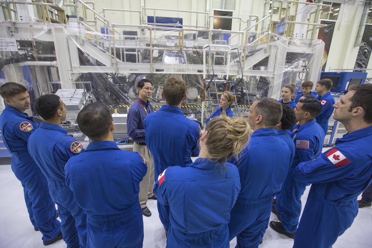 The 2017 class of astronaut candidates tour the Neil Armstrong Operations and Checkout Building high bay during a familiarization tour at NASA's Kennedy Space Center in Florida. In front, at right, is Glenn Chin, deputy manager, Orion Production Operations Office. The candidates toured center facilities, including the Vehicle Assembly Building; Launch Control Center, Launch Pad 39B and the Space Station Processing Facility. They also toured Boeing's Commercial Crew and Cargo Facility, and United Launch Alliance's Space Launch Complex 41 at Cape Canaveral Air Force Station. The candidates will spend about two years getting to know the space station systems and learning how to spacewalk, speak Russian, control the International Space Station's robotic arm and fly T-38s, before they're eligible to be assigned to a mission.