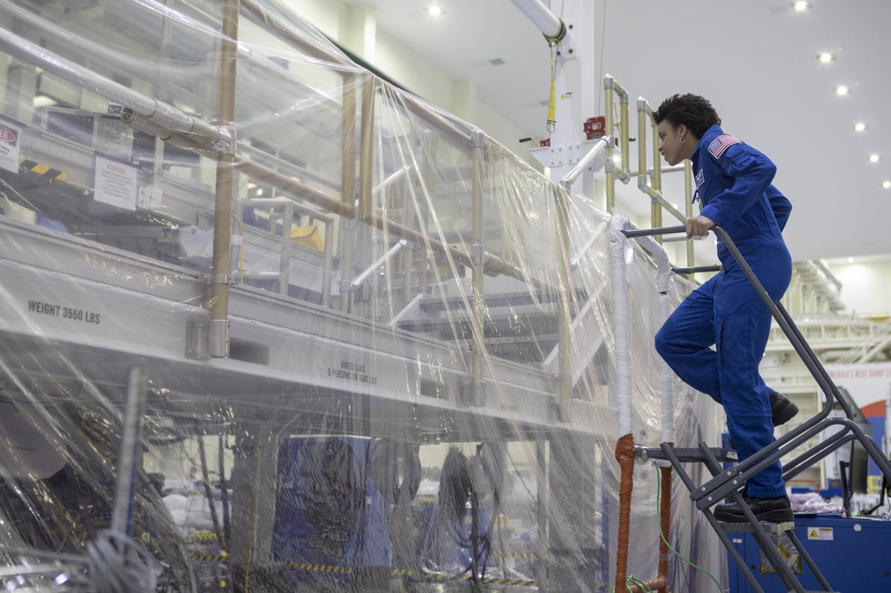A member of the 2017 class of astronaut candidates views the Orion crew module for Exploration Mission-1 inside the Neil Armstrong Operations and Checkout Building high bay during a familiarization tour at NASA's Kennedy Space Center in Florida. The candidates toured center facilities, including the Vehicle Assembly Building, Launch Pad 39B, the Launch Control Center and the Space Station Processing Facility. They also toured Boeing's Commercial Crew and Cargo Facility, and United Launch Alliance's Space Launch Complex 41 at Cape Canaveral Air Force Station. The candidates will spend about two years getting to know the space station systems and learning how to spacewalk, speak Russian, control the International Space Station's robotic arm and fly T-38s, before they're eligible to be assigned to a mission.
