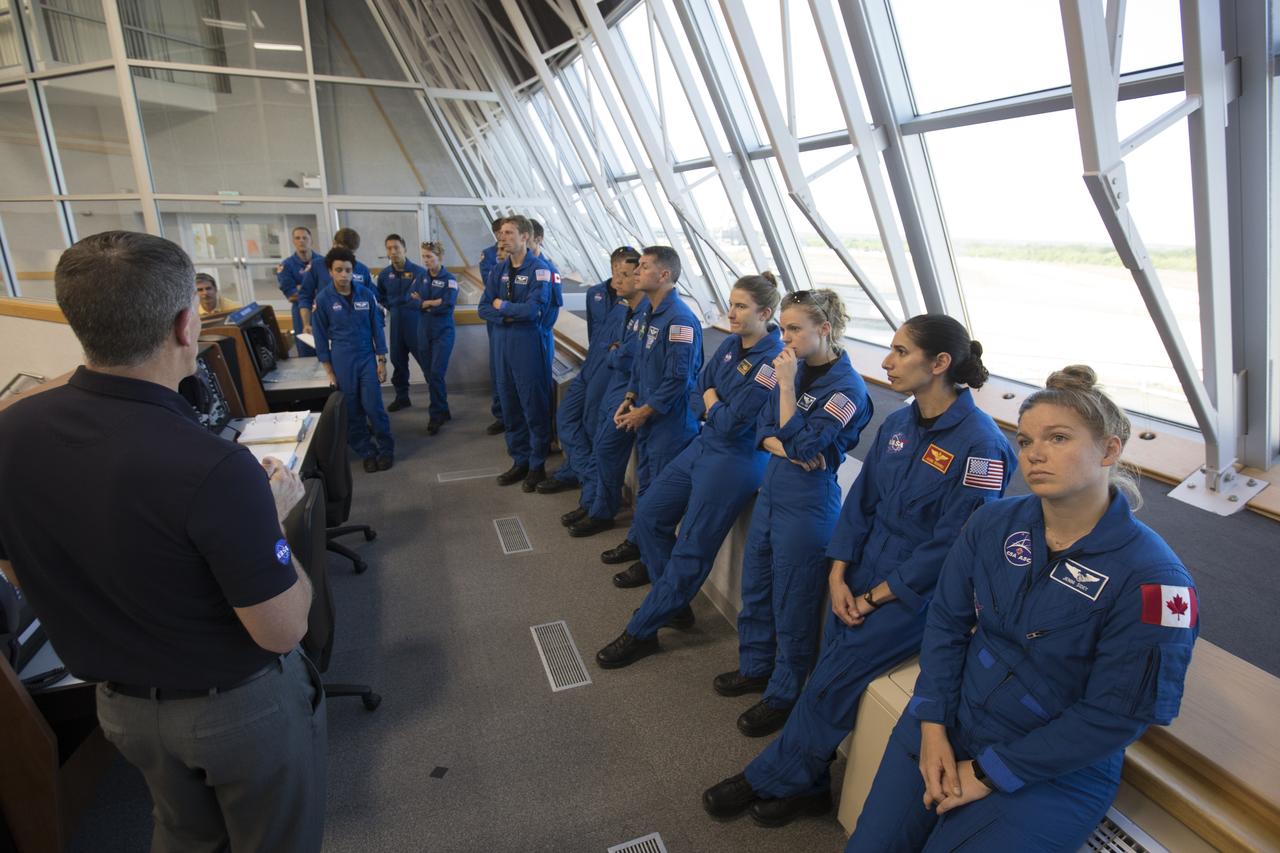 Member of the 2017 class of astronaut candidates are in Firing Room 1 inside the Launch Control Center during a familiarization tour at NASA's Kennedy Space Center in Florida. The candidates toured center facilities, including the Vehicle Assembly Building, Launch Pad 39B, the Neil Armstrong Operations and Checkout Building high bay and the Space Station Processing Facility. They also toured Boeing's Commercial Crew and Cargo Facility, United Launch Alliance's Space Launch Complex 41 at Cape Canaveral Air Force Station, and SpaceX's Launch Pad 39A at Kennedy. The candidates will spend about two years getting to know the space station systems and learning how to spacewalk, speak Russian, control the International Space Station's robotic arm and fly T-38s, before they're eligible to be assigned to a mission.