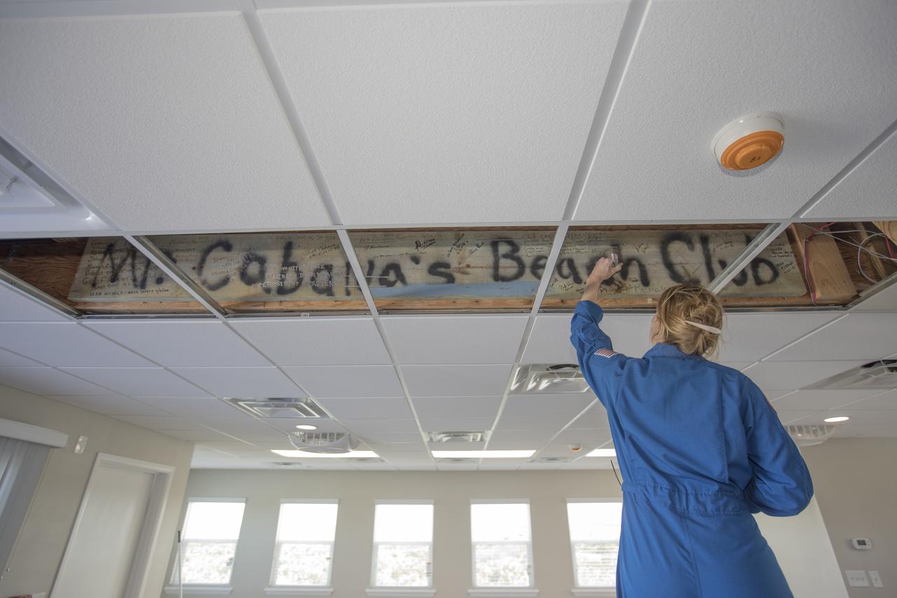 A members of the 2017 class of astronaut candidates signs her name to a wooden sign inside the Beach House during a familiarization tour at NASA's Kennedy Space Center in Florida. The candidates toured center facilities, including the Vehicle Assembly Building, Launch Control Center, Neil Armstrong Operations and Checkout Building high bay, Launch Pad 39B and the Space Station Processing Facility. They also toured Boeing's Commercial Crew and Cargo Facility, United Launch Alliance's Space Launch Complex 41 at Cape Canaveral Air Force Station, and SpaceX's Launch Pad 39A at Kennedy. The candidates will spend about two years getting to know the space station systems and learning how to spacewalk, speak Russian, control the International Space Station's robotic arm and fly T-38s, before they're eligible to be assigned to a mission.