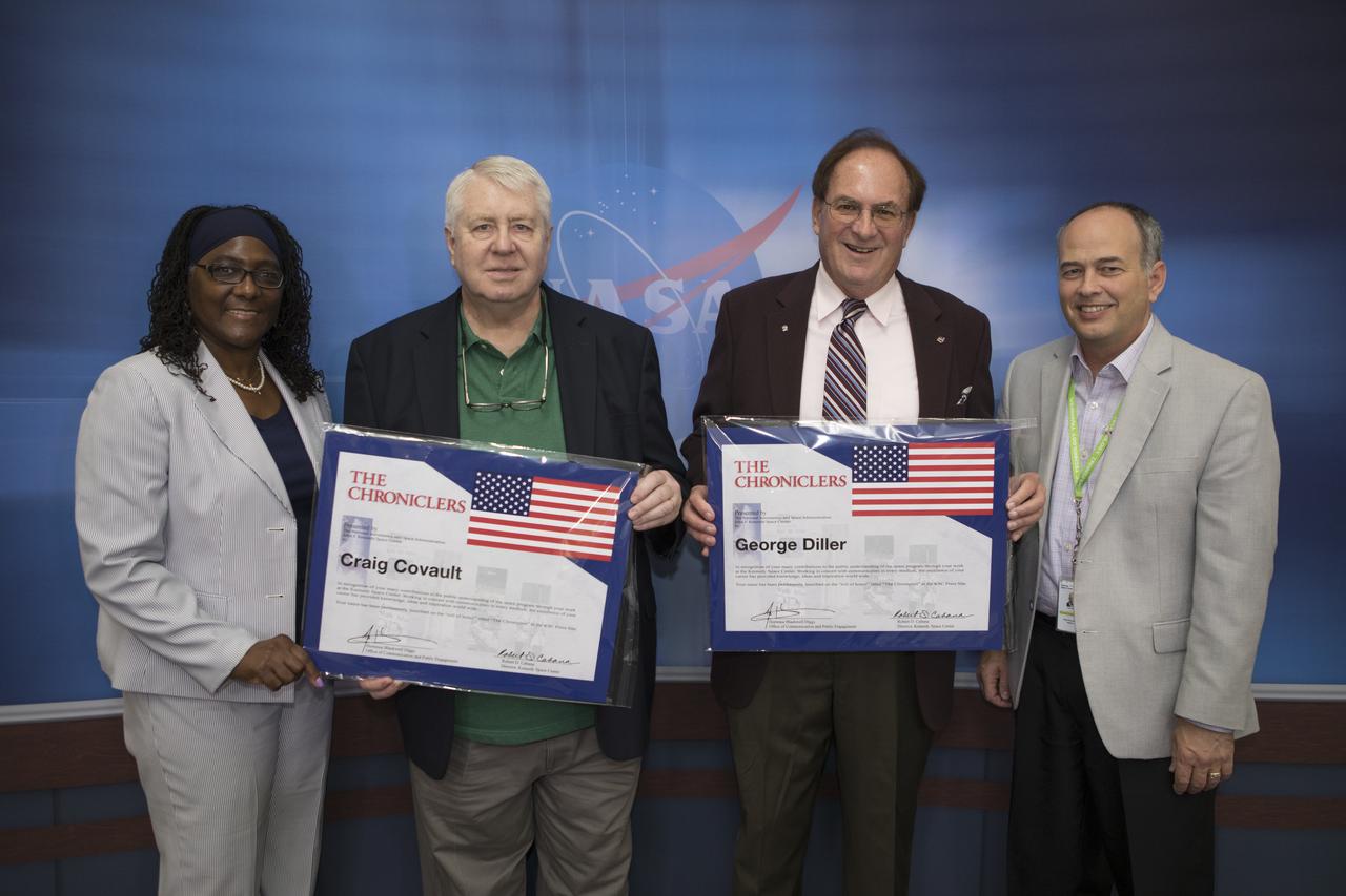 Craig Covault and George Diller are the newest additions to the “Chroniclers wall,” which recognizes retirees of the news and communications business who helped spread news of American space exploration from Kennedy Space Center in Florida for 10 years or more. The two men were honored during a gathering at Kennedy’s NASA News Center on Friday, May 4. Posing with the inductees are, far left, Hortense Diggs, Office of Communication and Public Engagement deputy director at Kennedy; and far right, Kennedy Office of Communication Division Chief David Culp. 