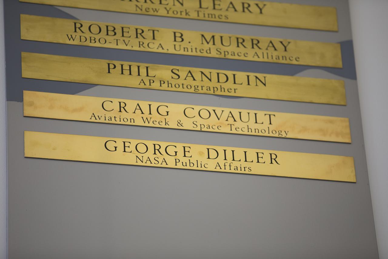 Brass strips engraved with the names of Craig Covault and George Diller were unveiled during a ceremony at Kennedy Space Center’s NASA News Center in Florida on Friday, May 4. Covault covered approximately 100 space shuttle launches and missions during his 48-year career. Diller was known by many as “The Voice of Kennedy Launch Control” during his 37-year career in NASA Public Affairs. “Chroniclers” recognizes retirees of the news and communications business who helped spread news of American space exploration from Kennedy for 10 years or more. 