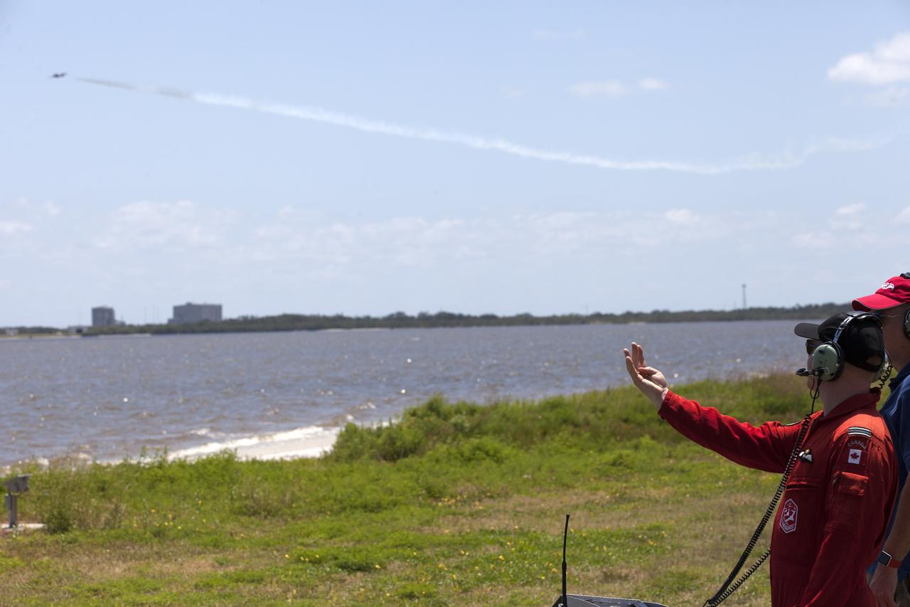 Capt. Blake McNaughton, team coordinator, Advance and Safety Pilot, 431 (Air Demonstration) Squadron Snowbirds Department of National Defence, communicates with the Canadian Forces Snowbird pilots from the NASA Causeway at Kennedy Space Center in Florida during a practice flight on May 9, 2018, between their scheduled U.S. Air Shows.