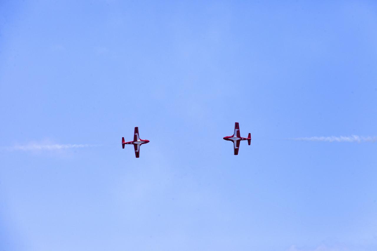 Two Canadian Forces Snowbirds perform an aerial maneuver over NASA's Kennedy Space Center in Florida during a practice flight on May 9, 2018, between their scheduled U.S. air shows.