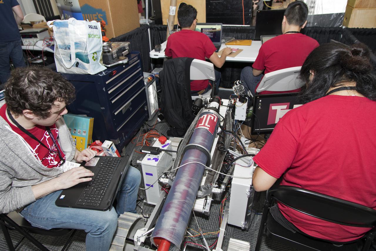 On the first day of NASA's 9th Robotic Mining Competition, set-up day on May 14, team members from Temple University work on their robot miner in the RobotPits in the Educator Resource Center at Kennedy Space Center Visitor Complex in Florida. More than 40 student teams from colleges and universities around the U.S. will use their mining robots to dig in a supersized sandbox filled with BP-1, or simulated Lunar soil, gravel and rocks, and participate in other competition requirements. The Robotic Mining Competition is a NASA Human Exploration and Operations Mission Directorate project designed to encourage students in science, technology, engineering and math, or STEM fields. The project provides a competitive environment to foster innovative ideas and solutions that could be used on NASA's deep space missions.