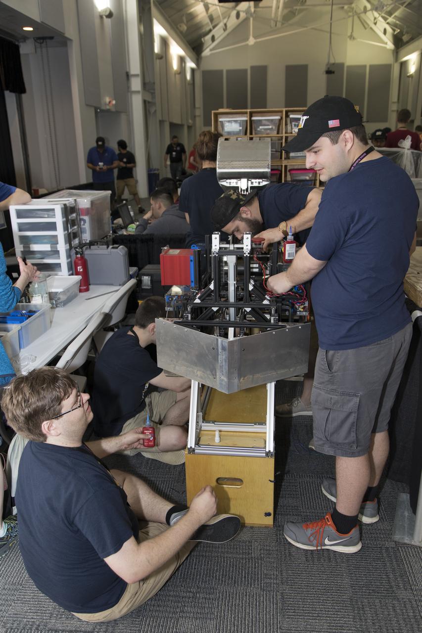 On the first day of NASA's 9th Robotic Mining Competition, set-up day on May 14, college team members work on their robot miner in the RobotPits in the Educator Resource Center at Kennedy Space Center Visitor Complex in Florida. More than 40 student teams from colleges and universities around the U.S. will use their mining robots to dig in a supersized sandbox filled with BP-1, or simulated Lunar soil, gravel and rocks, and participate in other competition requirements. The Robotic Mining Competition is a NASA Human Exploration and Operations Mission Directorate project designed to encourage students in science, technology, engineering and math, or STEM fields. The project provides a competitive environment to foster innovative ideas and solutions that could be used on NASA's deep space missions.