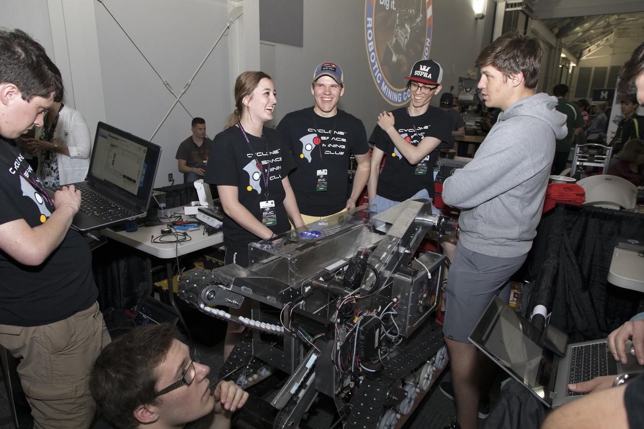 Team members from Iowa State University prepare their robot miner on the second day of NASA's 9th Robotic Mining Competition, May 15, in the RobotPits in the Educator Resource Center at Kennedy Space Center Visitor Complex in Florida. More than 40 student teams from colleges and universities around the U.S. will use their mining robots to dig in a supersized sandbox filled with BP-1, or simulated Lunar soil, gravel and rocks, and participate in other competition requirements. The Robotic Mining Competition is a NASA Human Exploration and Operations Mission Directorate project designed to encourage students in science, technology, engineering and math, or STEM fields. The project provides a competitive environment to foster innovative ideas and solutions that could be used on NASA's deep space missions.