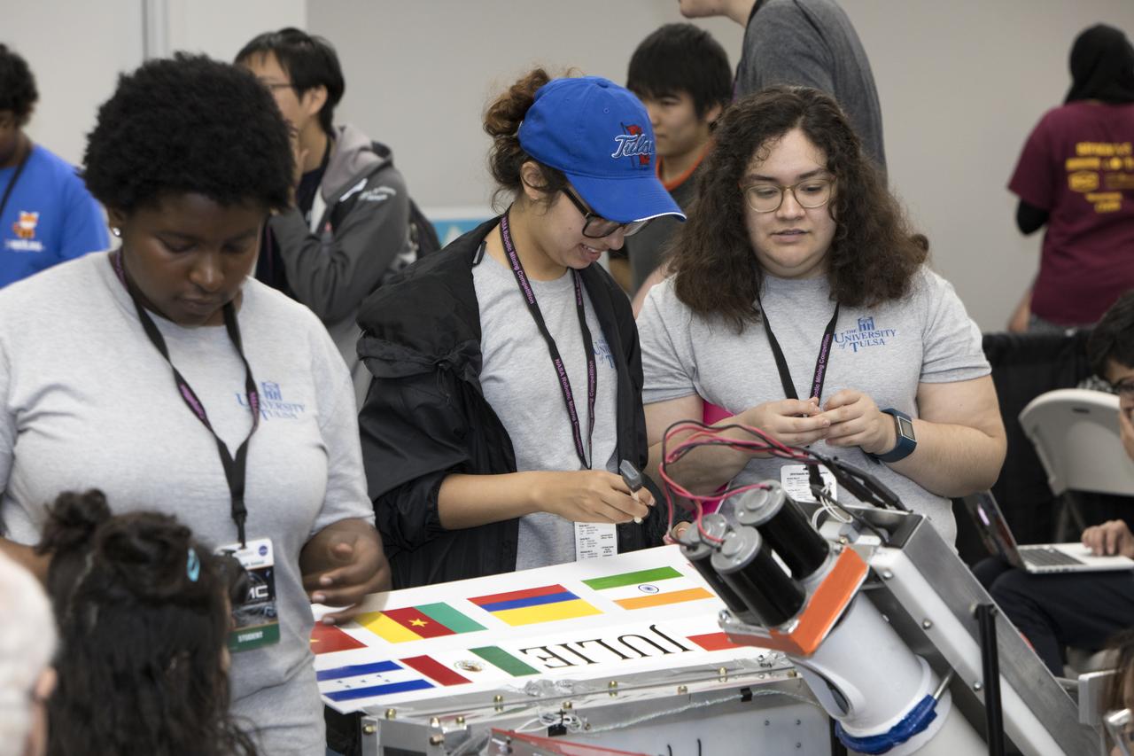 On the second day of NASA's 9th Robotic Mining Competition, May 15, team members from the University of Tulsa work on their robot miner in the RobotPits in the Educator Resource Center at Kennedy Space Center Visitor Complex in Florida. More than 40 student teams from colleges and universities around the U.S. will use their mining robots to dig in a supersized sandbox filled with BP-1, or simulated Lunar soil, gravel and rocks, and participate in other competition requirements. The Robotic Mining Competition is a NASA Human Exploration and Operations Mission Directorate project designed to encourage students in science, technology, engineering and math, or STEM fields. The project provides a competitive environment to foster innovative ideas and solutions that could be used on NASA's deep space missions.