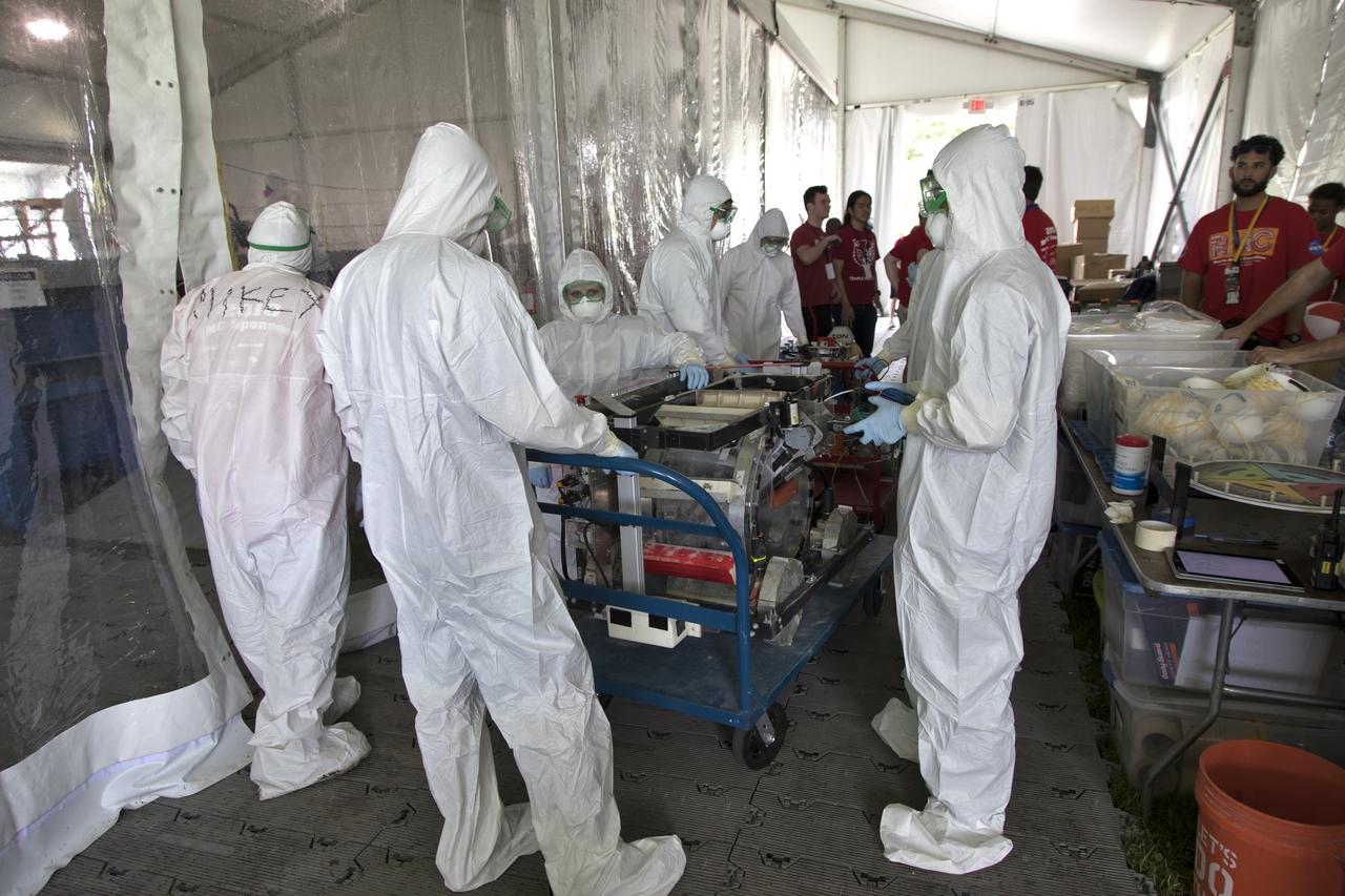 On the third day of NASA's 9th Robotic Mining Competition, May 16, team members prepare their robot miner for its turn in the mining arena at NASA's Kennedy Space Center Visitor Complex in Florida. More than 40 student teams from colleges and universities around the U.S. will use their mining robots to dig in a supersized sandbox filled with BP-1, or simulated Lunar soil, gravel and rocks, and participate in other competition requirements. The Robotic Mining Competition is a NASA Human Exploration and Operations Mission Directorate project designed to encourage students in science, technology, engineering and math, or STEM fields. The project provides a competitive environment to foster innovative ideas and solutions that could be used on NASA's deep space missions.