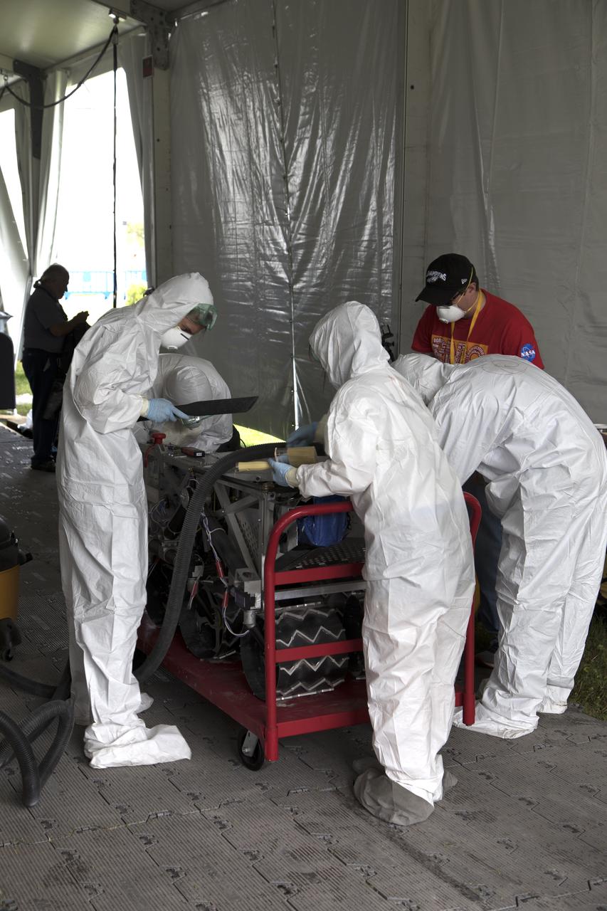 On the third day of NASA's 9th Robotic Mining Competition, May 16, a university team cleans their robot miner after its turn in the mining arena at NASA's Kennedy Space Center Visitor Complex in Florida. More than 40 student teams from colleges and universities around the U.S. will use their mining robots to dig in a supersized sandbox filled with BP-1, or simulated Lunar soil, gravel and rocks, and participate in other competition requirements. The Robotic Mining Competition is a NASA Human Exploration and Operations Mission Directorate project designed to encourage students in science, technology, engineering and math, or STEM fields. The project provides a competitive environment to foster innovative ideas and solutions that could be used on NASA's deep space missions.