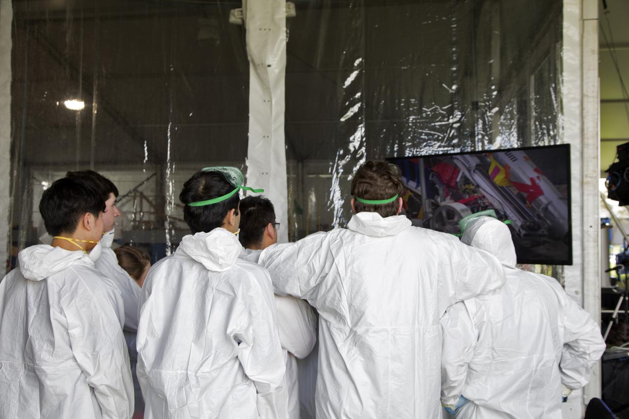 Members of a college team watch on the monitor as their robot miner digs in the mining arena on the third day of NASA's 9th Robotic Mining Competition, May 16, at NASA's Kennedy Space Center Visitor Complex in Florida. More than 40 student teams from colleges and universities around the U.S. will use their mining robots to dig in a supersized sandbox filled with BP-1, or simulated Lunar soil, gravel and rocks, and participate in other competition requirements. The Robotic Mining Competition is a NASA Human Exploration and Operations Mission Directorate project designed to encourage students in science, technology, engineering and math, or STEM fields. The project provides a competitive environment to foster innovative ideas and solutions that could be used on NASA's deep space missions. 