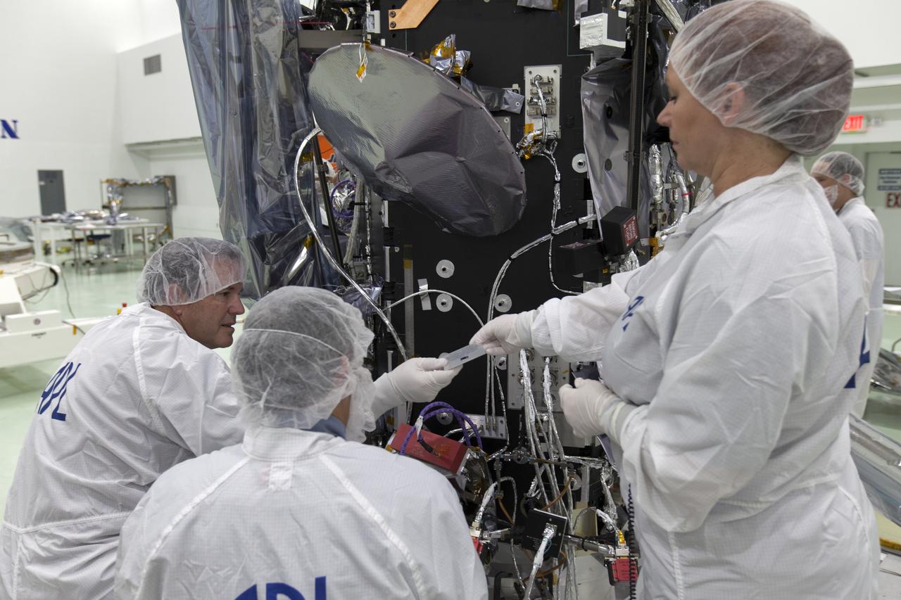 On Friday, May 18, 2018, at the Astrotech processing facility in Titusville, Florida, near NASA's Kennedy Space Center, scientists and engineers from the Applied Physics Laboratory at Johns Hopkins University install a computer chip on NASA's Parker Solar Probe. Throughout its seven-year mission, NASA’s Parker Solar Probe will swoop through the Sun’s atmosphere, carrying more than scientific instruments on this historic journey — it will also hold more than 1.1 million names submitted by the public to go to the Sun. The submitted names were loaded into a memory card and mounted on a plaque bearing a dedication to the mission’s namesake, heliophysicist Dr. Eugene Parker. The Parker Solar Probe will launch on a United Launch Alliance Delta IV Heavy rocket from Space Launch Complex 37 at Cape Canaveral Air Force Station in Florida no earlier than Aug. 4, 2018. The mission will perform the closest-ever observations of a star when it travels through the Sun's atmosphere, called the corona. The probe will rely on measurements and imaging to revolutionize our understanding of the corona and the Sun-Earth connection.