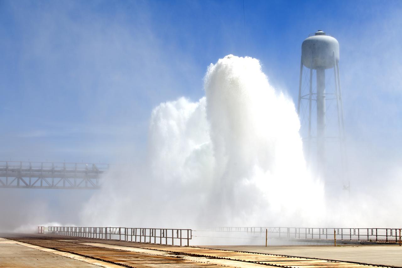 About 450,000 gallons of water flow at high speed from a holding tank through new and modified piping and valves, the flame trench, flame deflector nozzles and mobile launcher interface risers during a wet flow test on May 24, 2018, at Launch Pad 39B at NASA's Kennedy Space Center in Florida. At peak flow, the water reached about 100 feet in the air above the pad surface. The test was performed by Exploration Ground Systems to confirm the performance of the Ignition Overpressure/Sound Suppression system. During launch of NASA's Space Launch System rocket and Orion spacecraft, the high-speed water flow will help protect the vehicle from the extreme acoustic and temperature environment during ignition and liftoff.