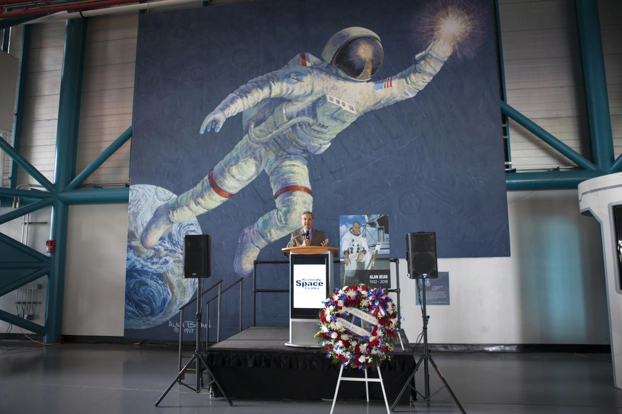 A memorial wreath placed in the Apollo-Saturn V Center of the Kennedy Space Center Visitor Complex on Wednesday, May 30, 2018, honors former NASA astronaut Alan Bean. He was the fourth person to walk on the Moon as lunar module pilot on Apollo 12 in November 1969. He went on to command the 59-day Skylab 3 mission in 1973. In the background is a large mural of a painting by Bean who became an accomplished artist after leaving NASA. He died in Houston on May 26, 2018, at the age of 86.