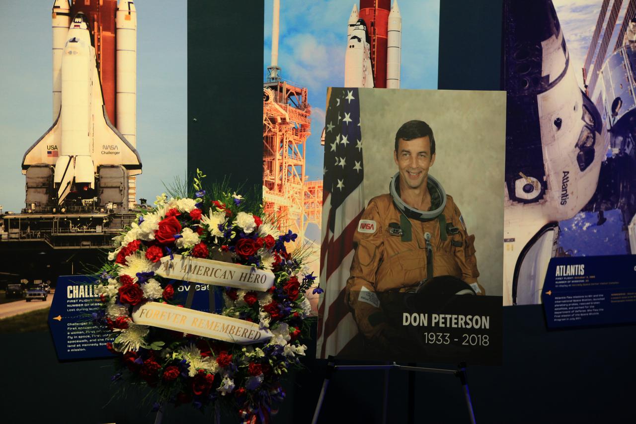 A memorial wreath placed in the Space Shuttle Atlantis exhibit at the Kennedy Space Center Visitor Complex on Wednesday, May 30, 2018, honoring former NASA astronaut Don Peterson. As a mission specialist on STS-6 in April 1983, he participated in the first spacewalk of the Space Shuttle Program. He passed away May 27, 2018, in El Lago, Texas. He was 84.