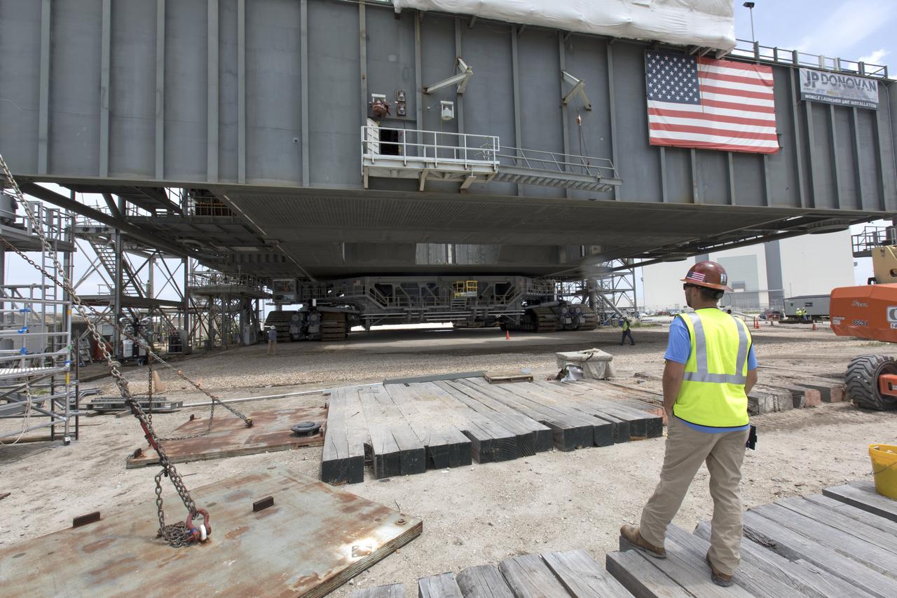 Crawler-transporter 2 (CT-2) is underneath the mobile launcher May 31, 2018, at NASA's Kennedy Space Center in Florida. Three lifts were performed to practice lifting procedures, validate interface locations, confirm the weight of the mobile launcher, and develop a baseline for modal analysis. The mobile launcher is equipped with a number of lines, called umbilicals, which will connect to NASA's Space Launch System (SLS) and Orion. CT-2 has been upgraded to handle the weight of the mobile launcher with SLS and Orion atop. Exploration Ground Systems is preparing the ground systems necessary to support the SLS and Orion spacecraft for Exploration Mission-1 and deep space missions.